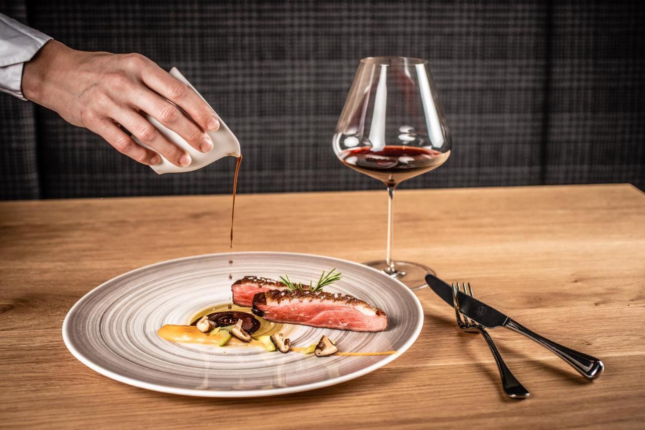 Hotel My Arbor - Dolomites Brixen Exterior foto A server pouring sauce onto a prepared dish